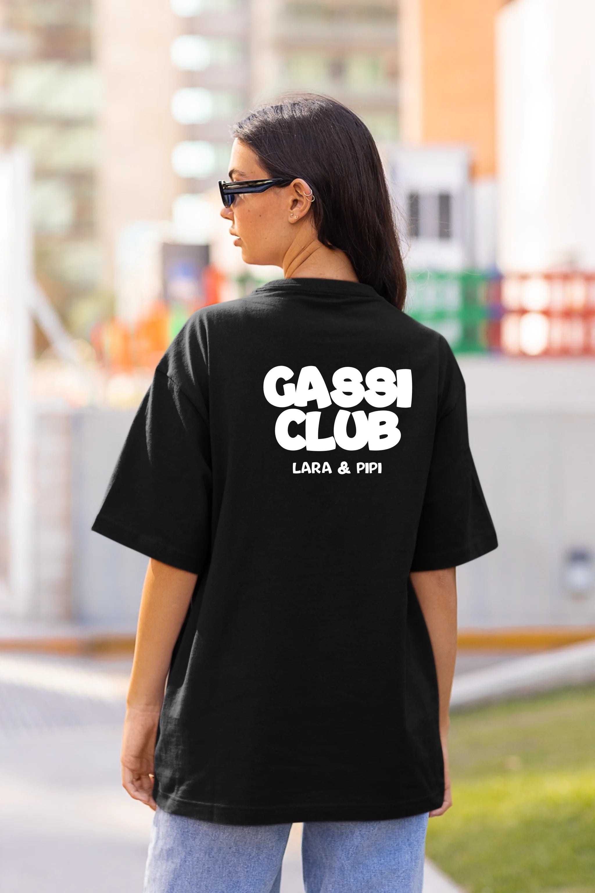 back-view-mockup-of-a-woman-in-an-oversized-t-shirt-on-the-street-m25267 (1)